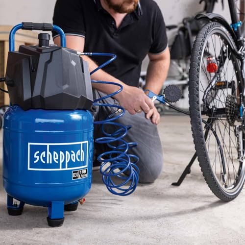 Homme utilisant compresseur Scheppach HC24V pour gonfler pneu vélo dans garage atelier